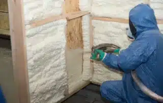 Contractor installing spray foam insulation
