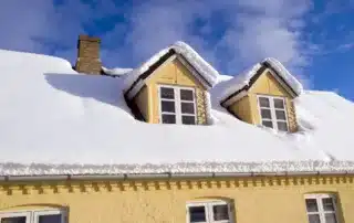 A house with snow on it that requires proper insulation